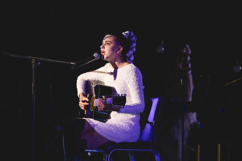Sirine performing vocals and guitar at True Colours Festival in Tokyo.